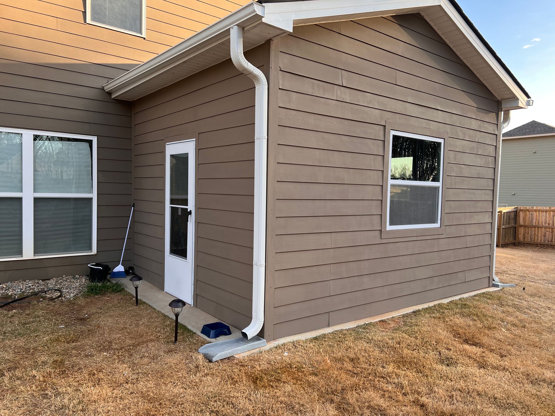 Carpenter at Lock Installation With Electric Drill Into Interior Wood Door