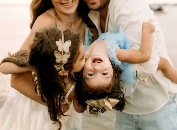 A family is posing for a picture on the beach in Point Pleasant, NJ.