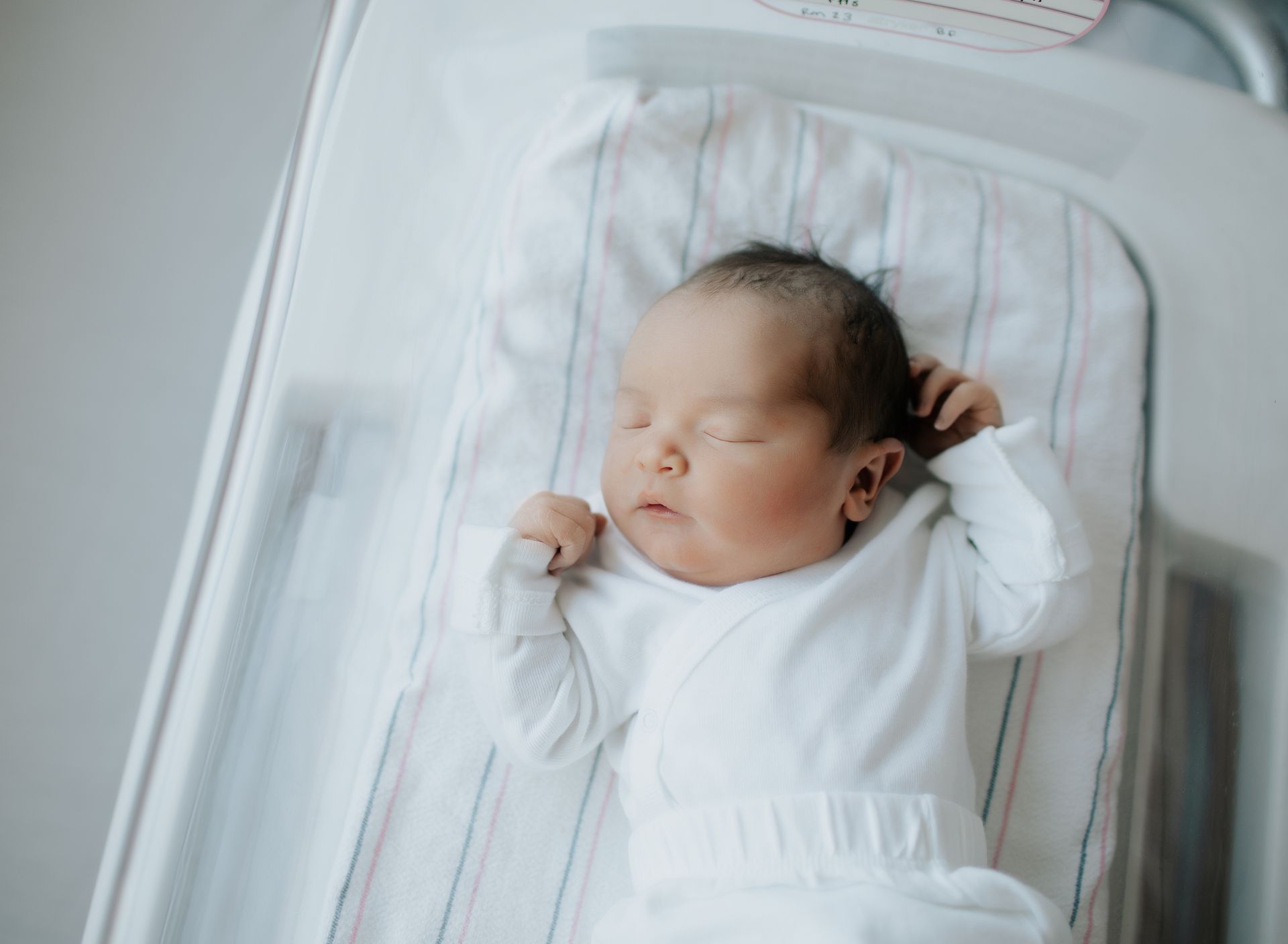 A newborn baby is sleeping in a hospital bed in Morristown Medical Center having her photoshoot.