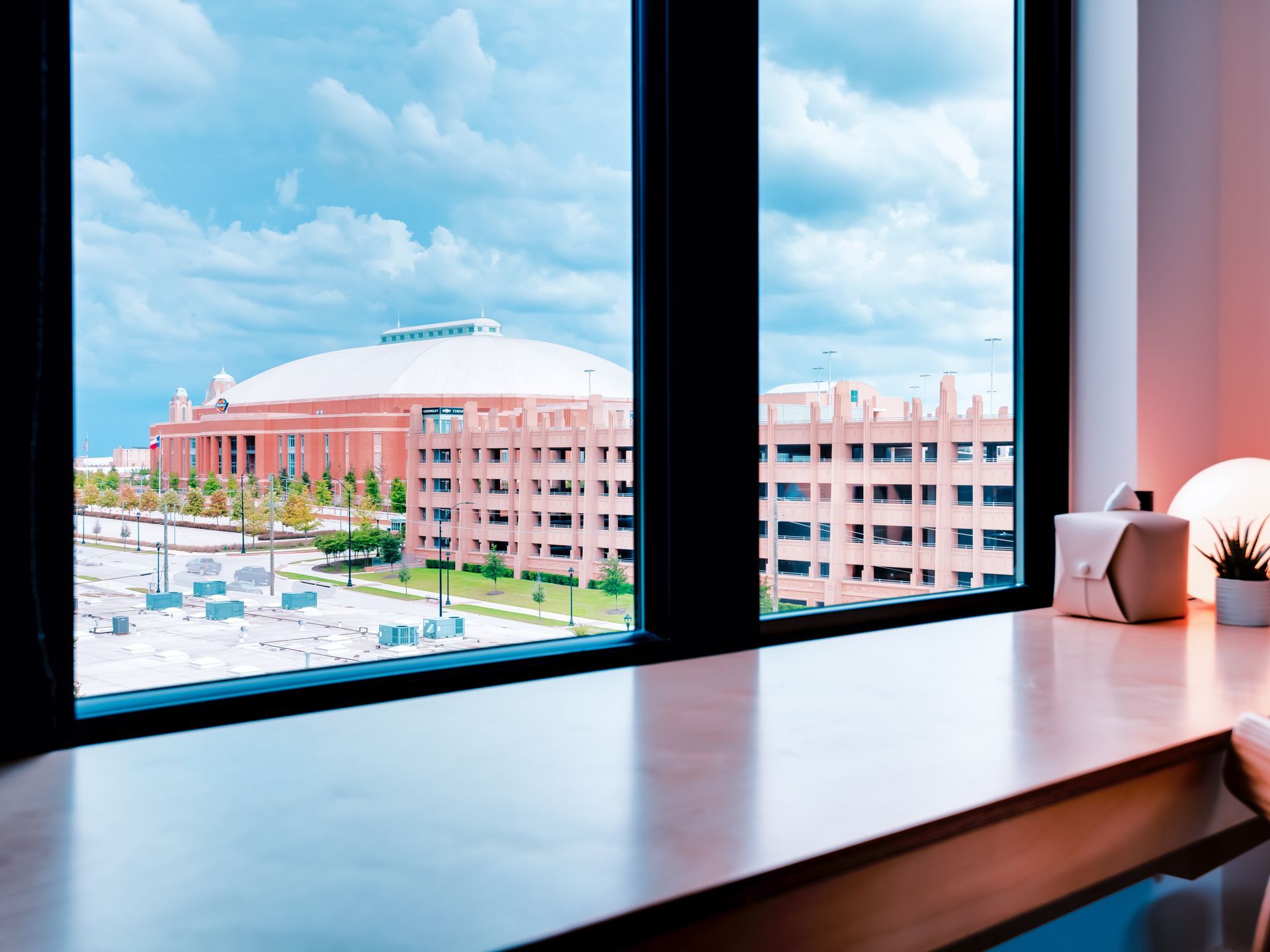 A large window with a view of a city and a building.