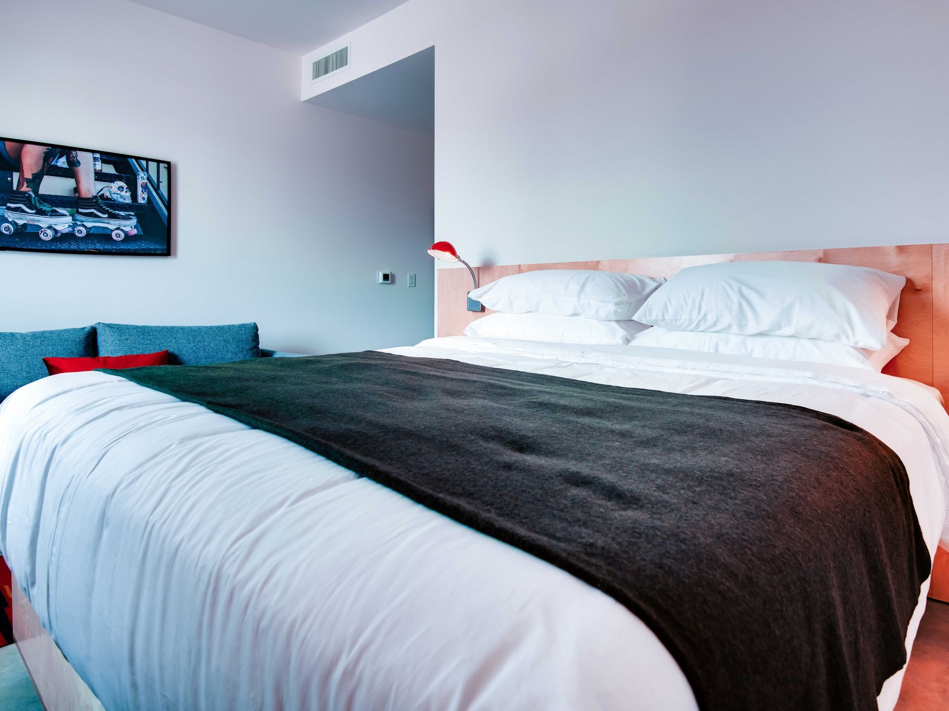 A hotel room with a large bed and a couch