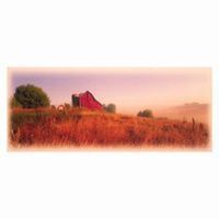 Red barn in a field of tall, reddish-brown grass under a hazy, pastel-colored sky.