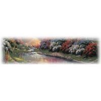 A stream flows through a colorful landscape of bushes and trees.