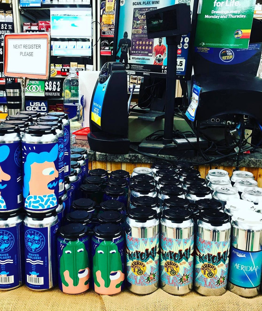 Convenience store display of colorful canned drinks and merchandise near the checkout counter