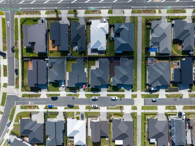 An aerial view of a large house with solar panels on the roof.