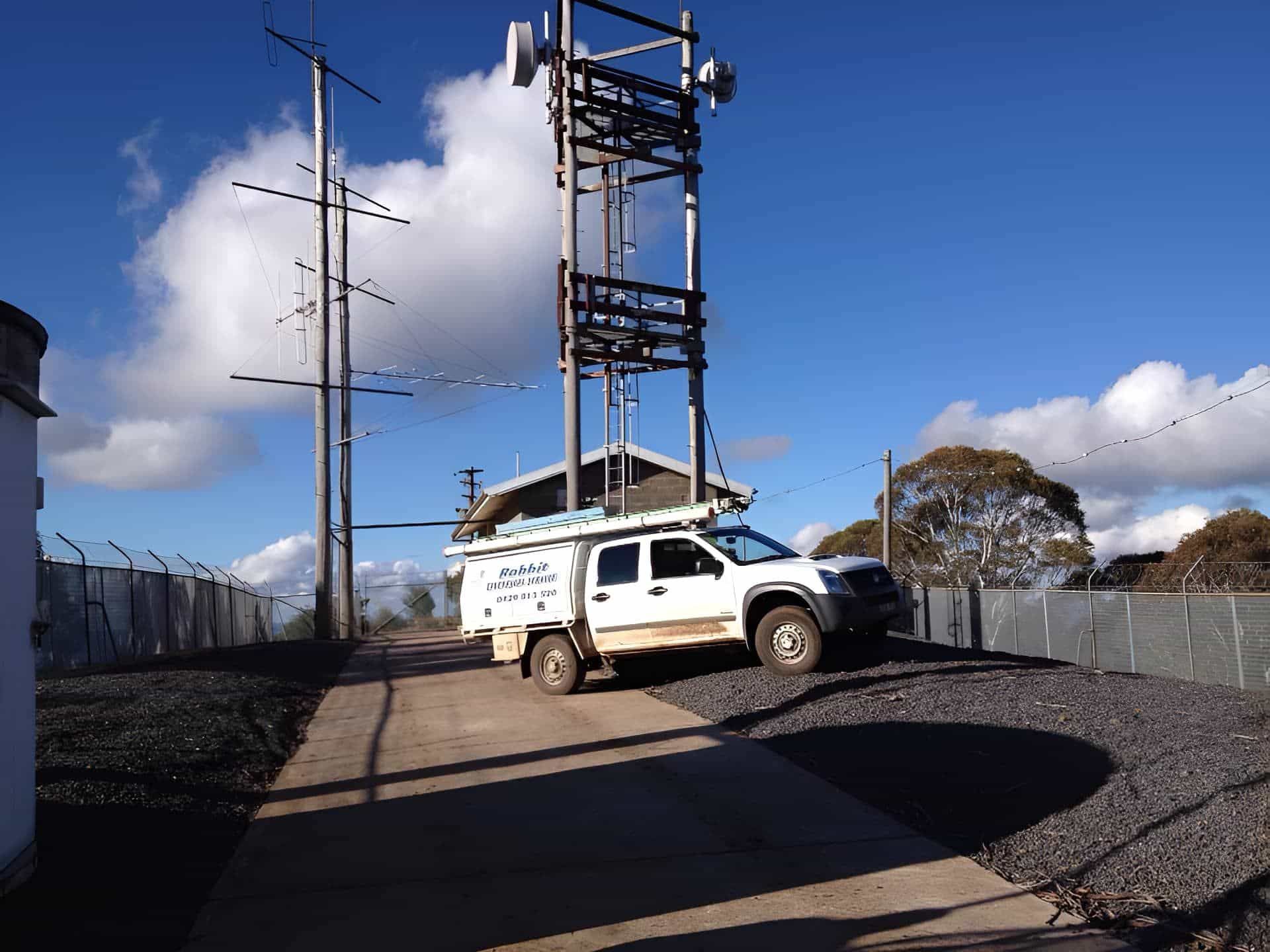 A White Truck is Parked in Front of a Pole — Rabbit Electrical Service In Taminda, NSW