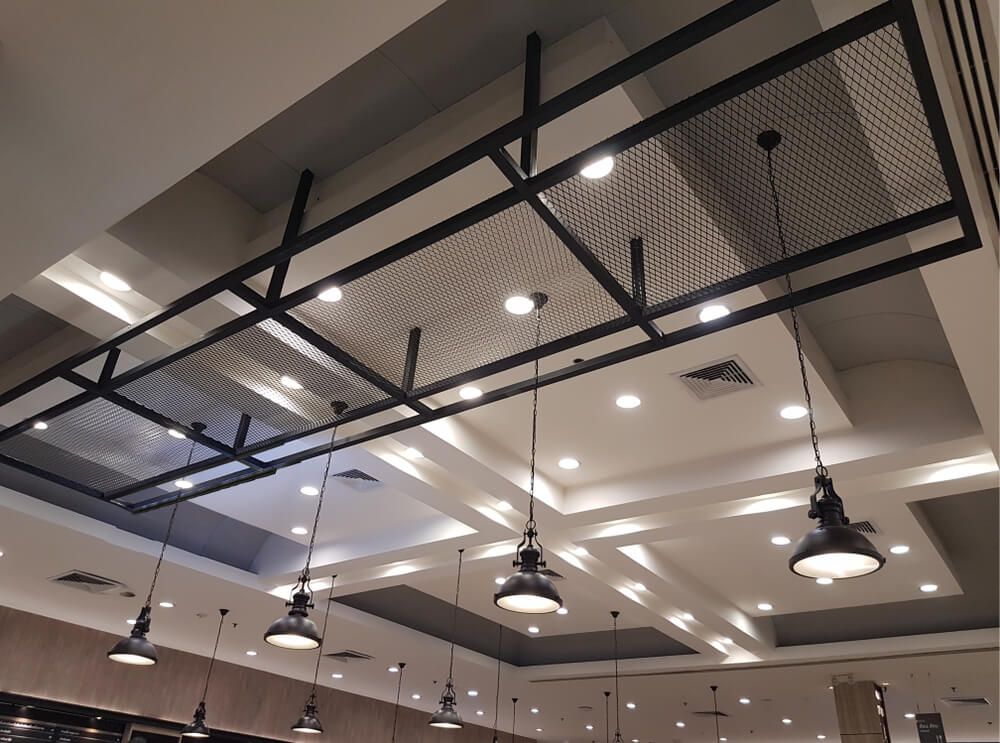 The ceiling of a restaurant with lots of lights hanging from it — Rabbit Electrical Service In Moree, NSW