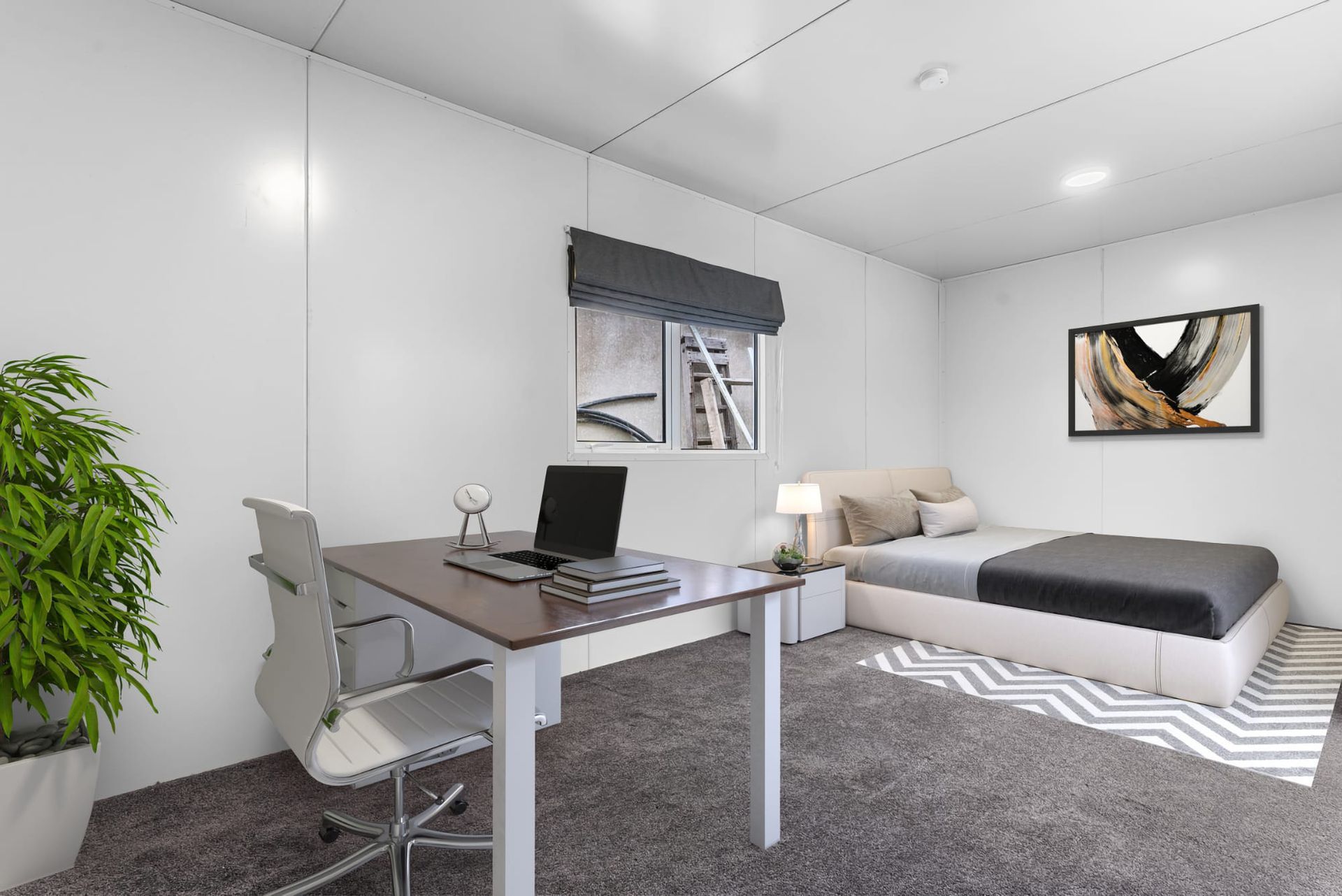 Modern bedroom office with desk, laptop, chair, bed, and white walls