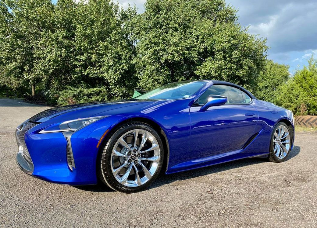 Blue Lexus LC convertible parked on asphalt.