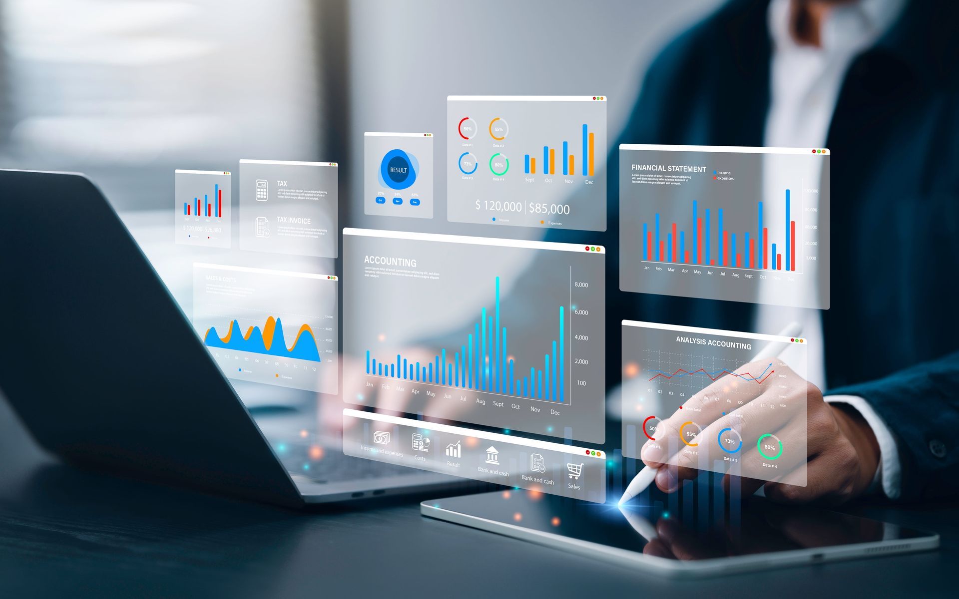 Person analyzing data visualizations displayed on a laptop and tablet with a stylus.