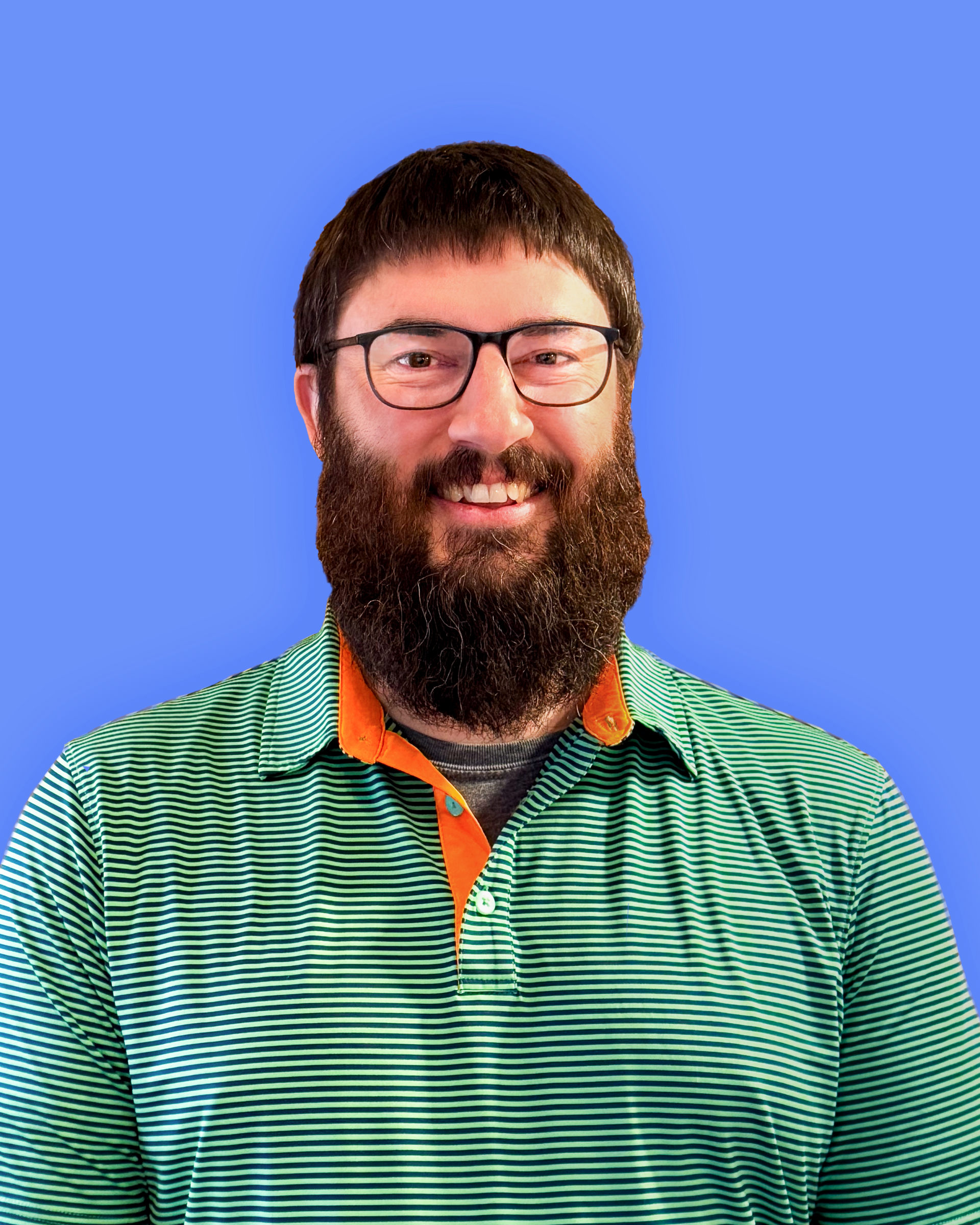 A man with a beard and glasses is wearing an orange hoodie.