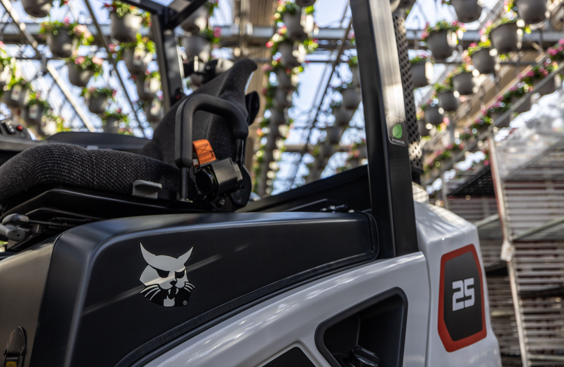 Black-and-white utility vehicle close-up under a pergola with hanging lights