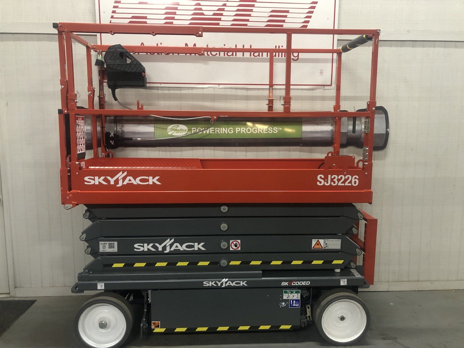 Red Skyjack SJ3226 scissor lift with black platform, shown side view on white background.