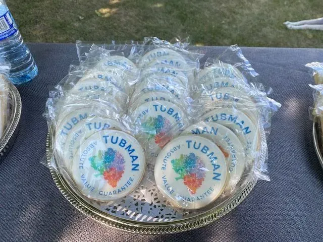 Tray of wrapped Tubman-themed cookies on a table outdoors.