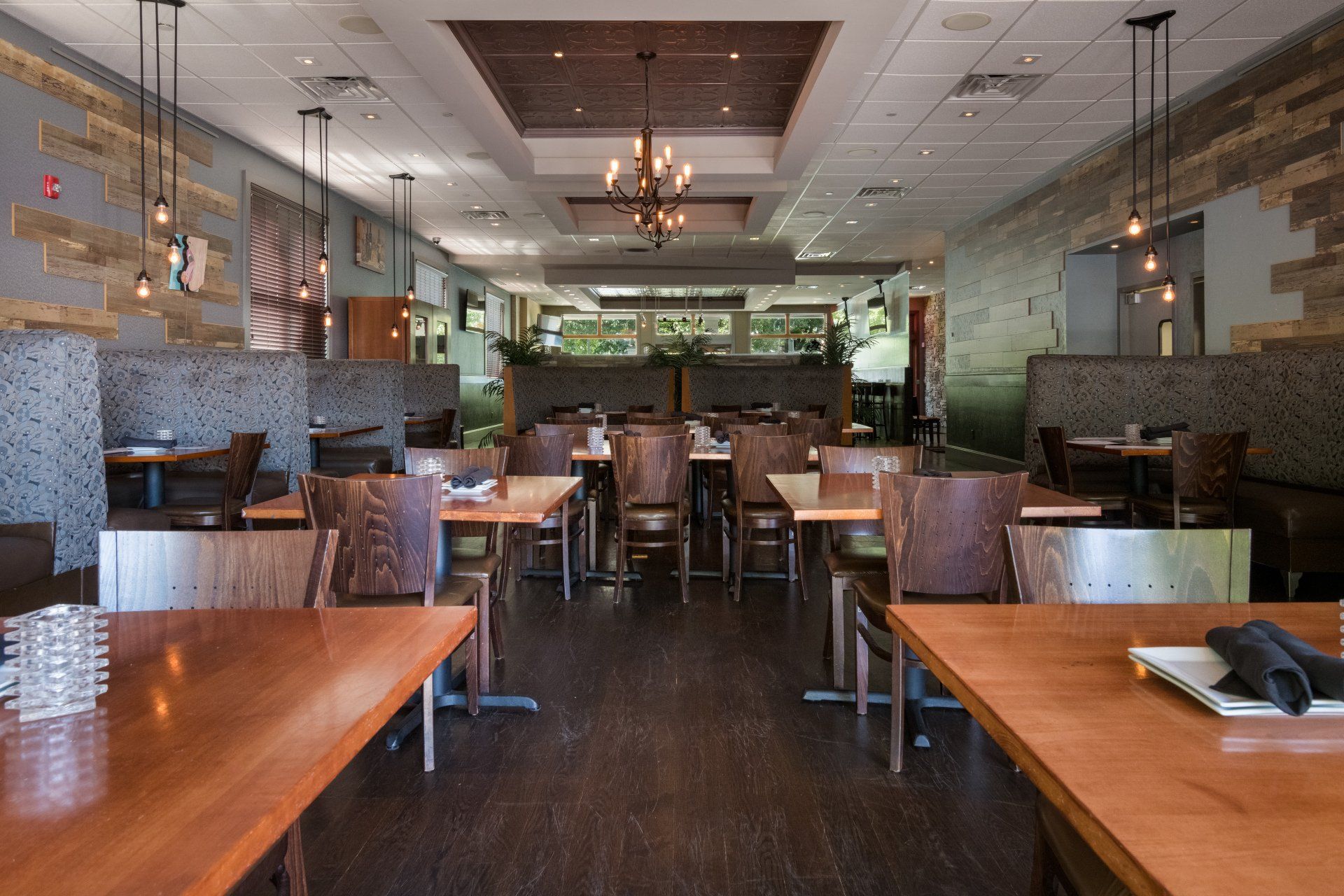 A restaurant with tables and chairs and a notebook on a table