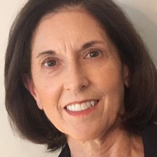 A close up of a woman 's face smiling.