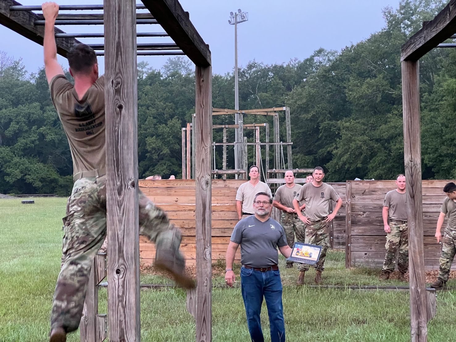 A man in a military uniform is climbing a wooden ladder. A man in a military uniform is climbing a wooden ladder.