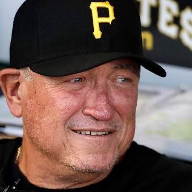 A man wearing a black baseball cap with the letter p on it. A man wearing a black baseball cap with the letter p on it.