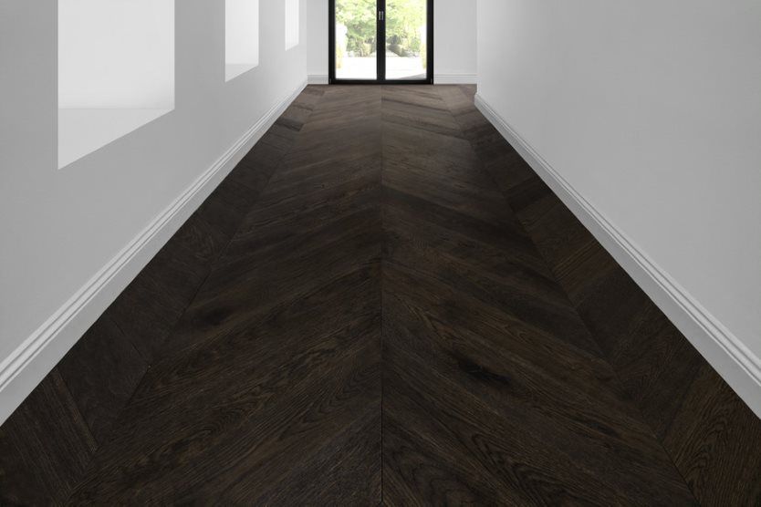 An Empty Hallway With A Wooden Floor And White Walls — Flooring Suppliers in Port Macquarie, NSW