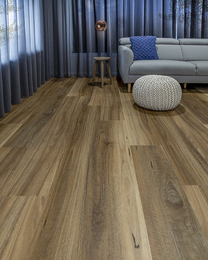 A Living Room With Hardwood Floors And A Couch — Flooring Suppliers in Port Macquarie, NSW