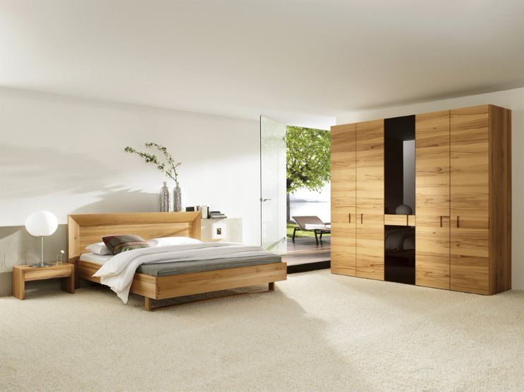 A Bedroom with a Wooden Bed and a Wooden Wardrobe — Flooring Suppliers in Port Macquarie, NSW