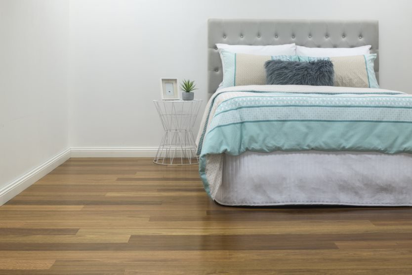 Cozy Bedroom with Timber Flooring — Flooring Suppliers in Wauchope, NSW