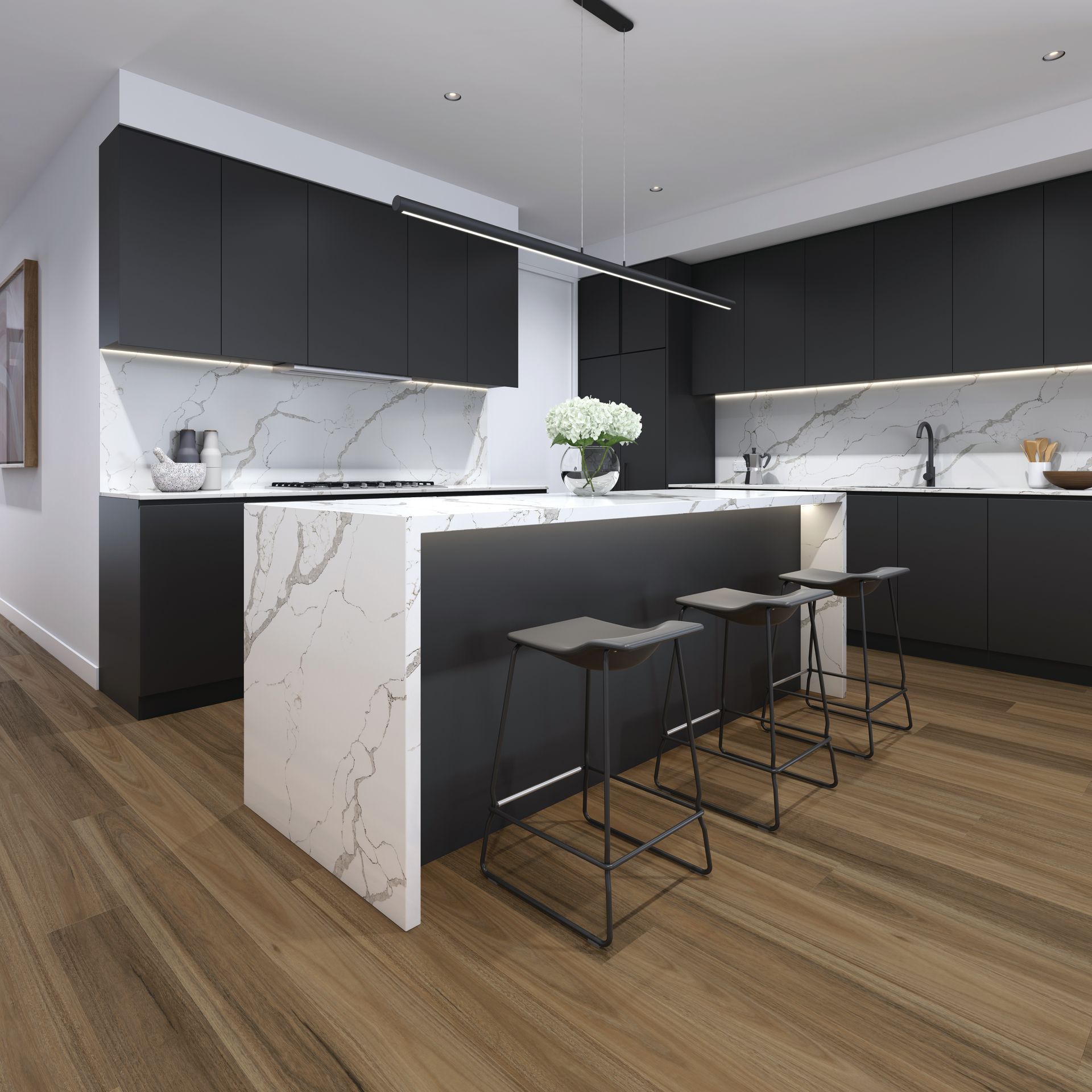 A kitchen with black cabinets and marble counter tops