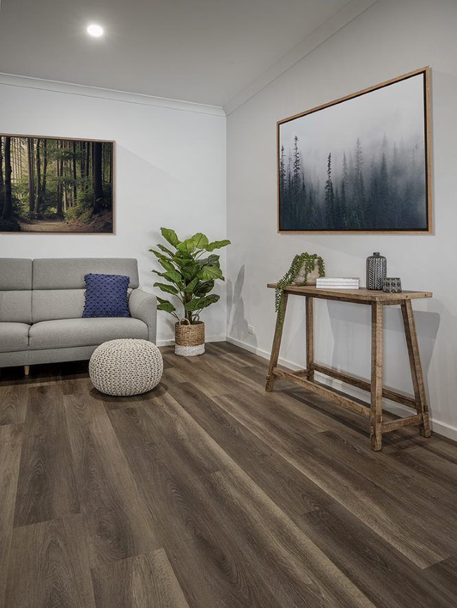 A Living Room With A Couch , Table , And Painting On The Wall — Flooring Suppliers in Port Macquarie, NSW