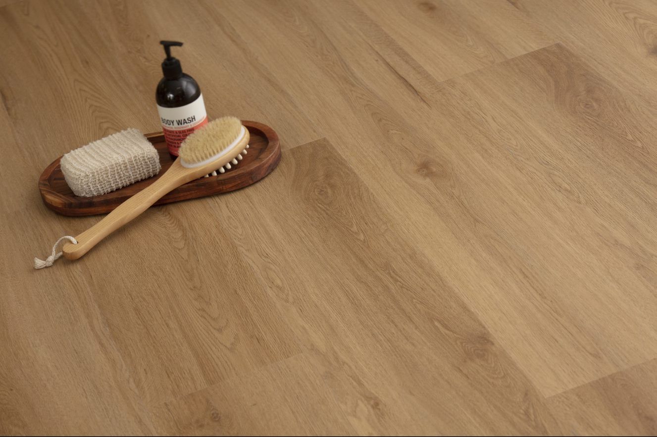 A Wooden Floor With A Brush And Soap On It — Flooring Suppliers in Port Macquarie, NSW
