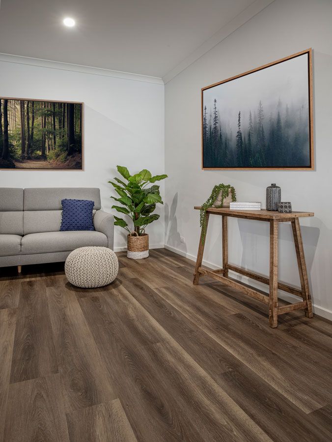 A Living Room With A Couch, Table, And Painting On The Wall — Flooring Suppliers in Port Macquarie, NSW