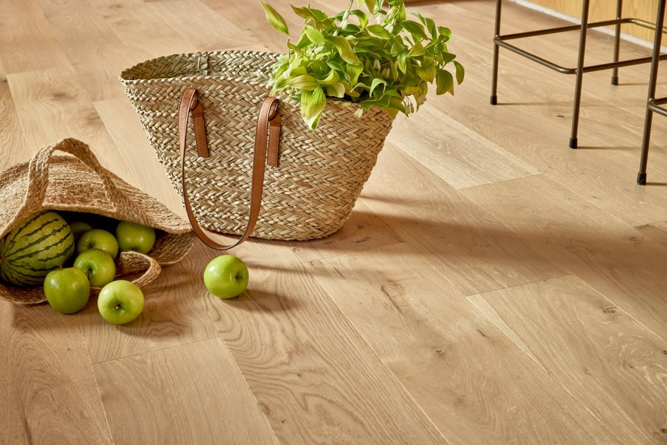 A Basket Filled With Green Apples And A Bag Of Watermelon On A Wooden Floor — Floor Coverings in Kempsey, NSW