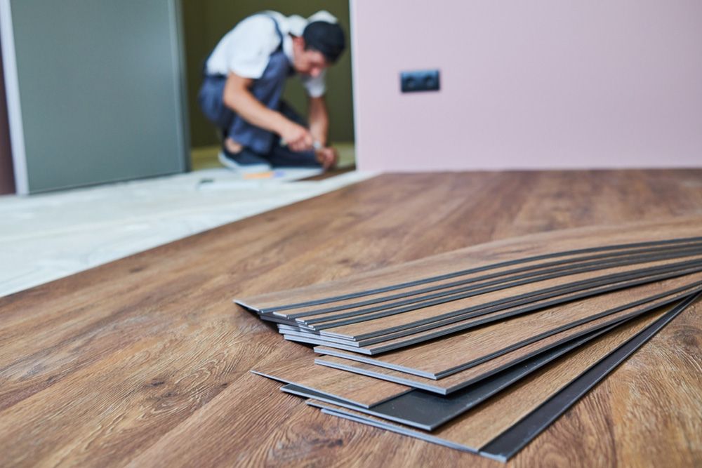 Man fixing the flooring of the house — Floor Coverings in Kempsey, NSW