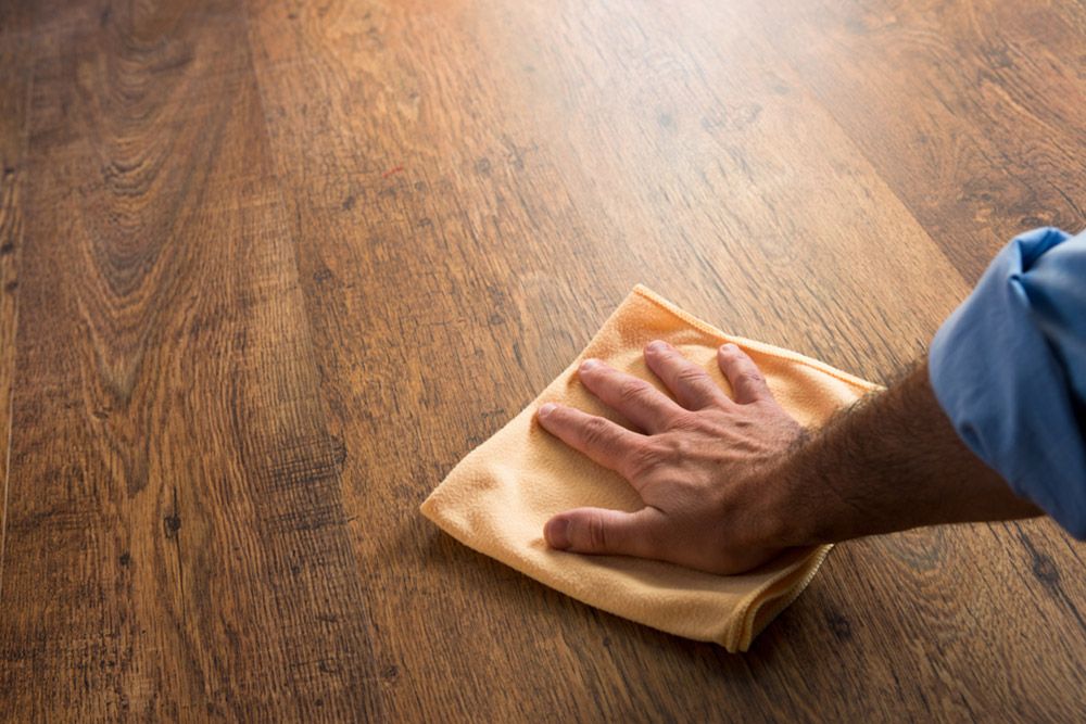 Man wiping the floor — Floor Coverings in Harrington, NSW