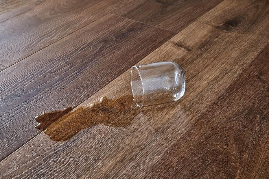 A Glass Of Water Spilled On A Wooden Floor — Flooring Suppliers in Port Macquarie, NSW