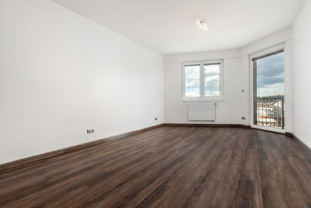 Room with dark vinyl with balcony overview — Floor Coverings in Harrington, NSW