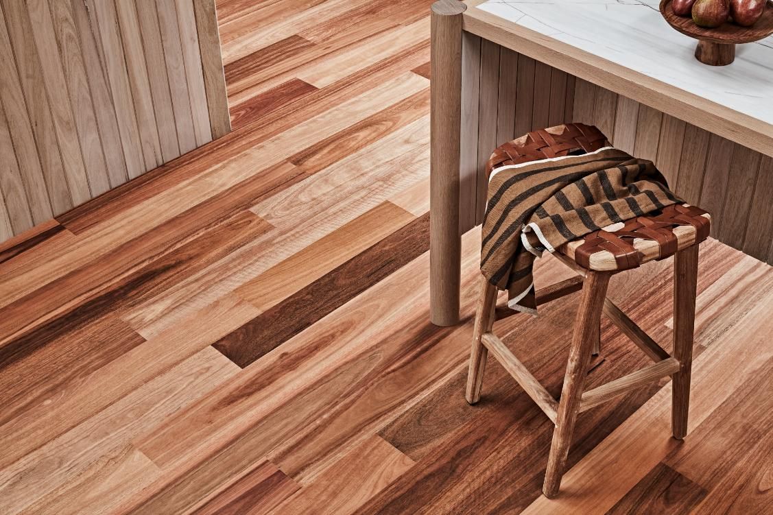 A Wooden Stool With A Blanket On It Is Sitting Next To A Wooden Table — Floor Coverings in South West Rocks, NSW
