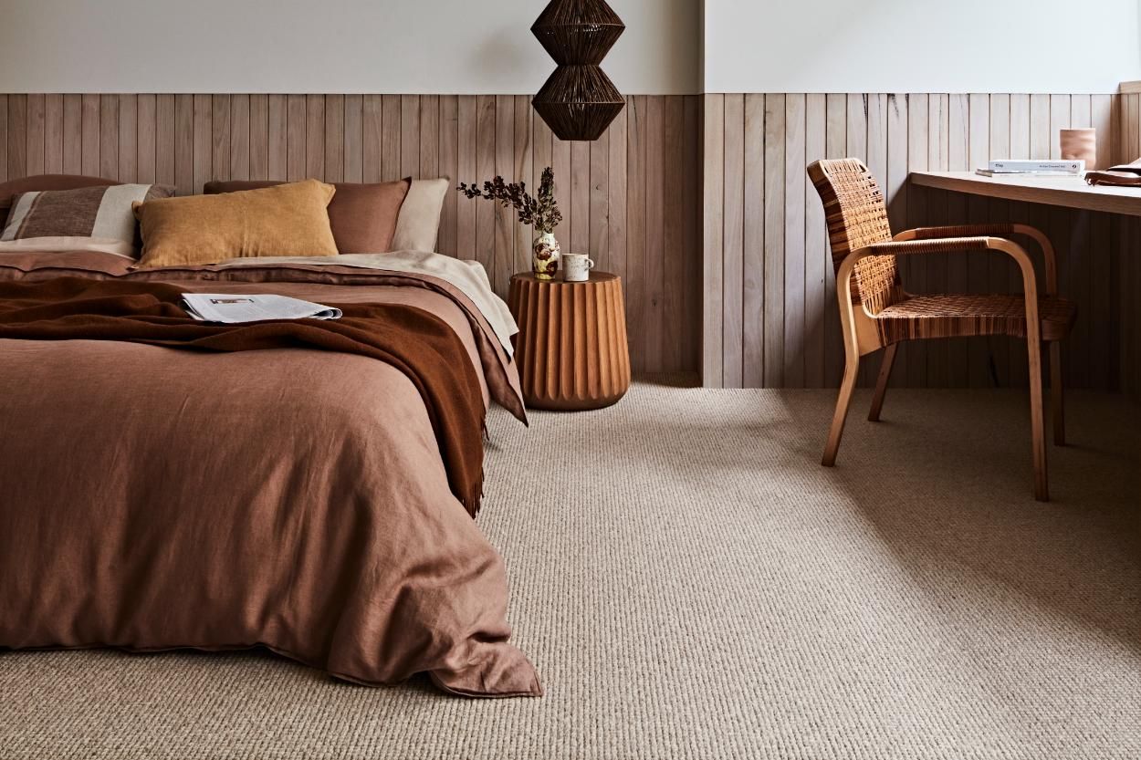 A Bedroom With A Bed, Desk, Chair And Carpet — Floor Coverings in Taree, NSW