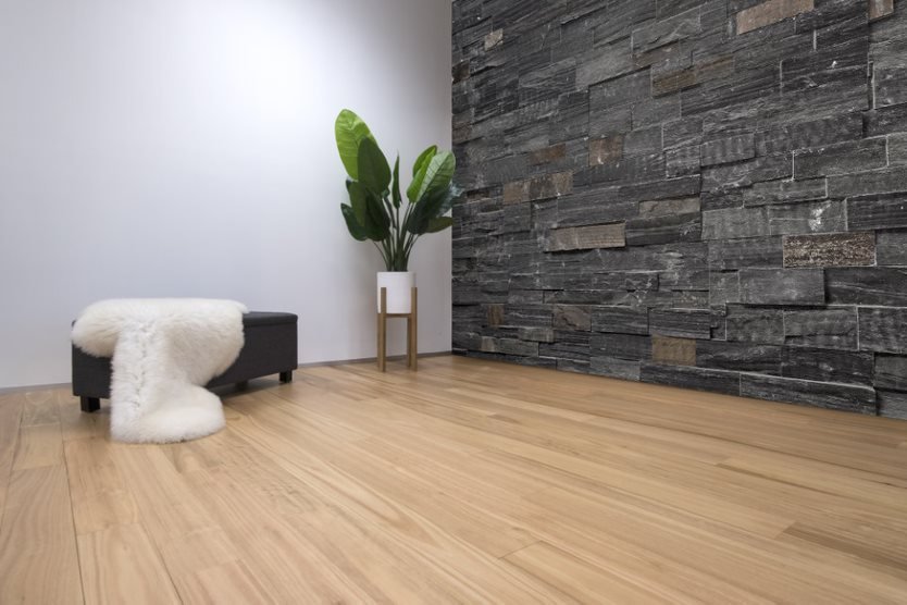 Timber Flooring with Stone Feature Wall — Flooring Suppliers in Port Macquarie, NSW