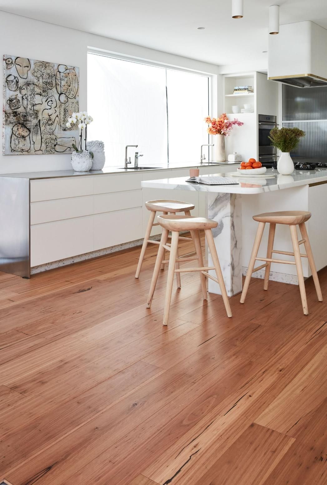 A Kitchen with 3 Chairs and Wooden Floor — Flooring Suppliers in Port Macquarie, NSW