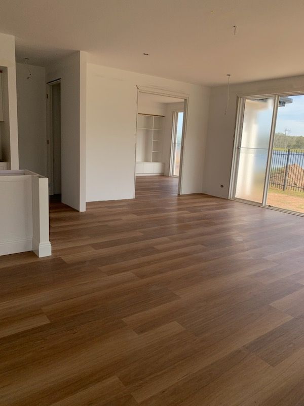 A Set Of Wooden Stairs With A White Railing — Flooring Suppliers in Port Macquarie, NSW