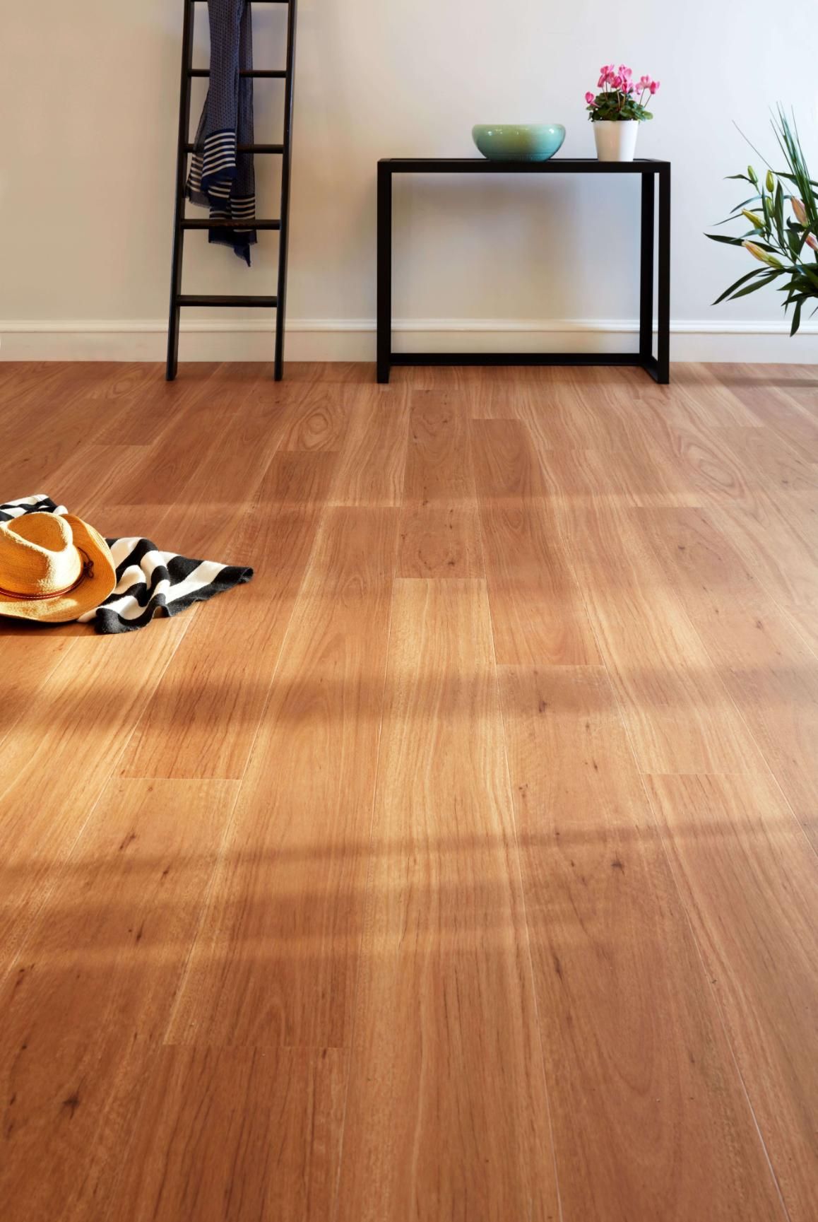 A Wooden Floor In A Living Room With A Ladder And A Table with a Hat on the Floor — Flooring Suppliers in Port Macquarie, NSW