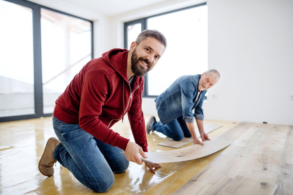 Two man helping each other to install the vinyl — Floor Coverings in South West Rocks, NSW