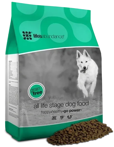 Bag of Life Abundance grain-free all life stage dog food; white dog running on gray background, dog food kibble spilled.