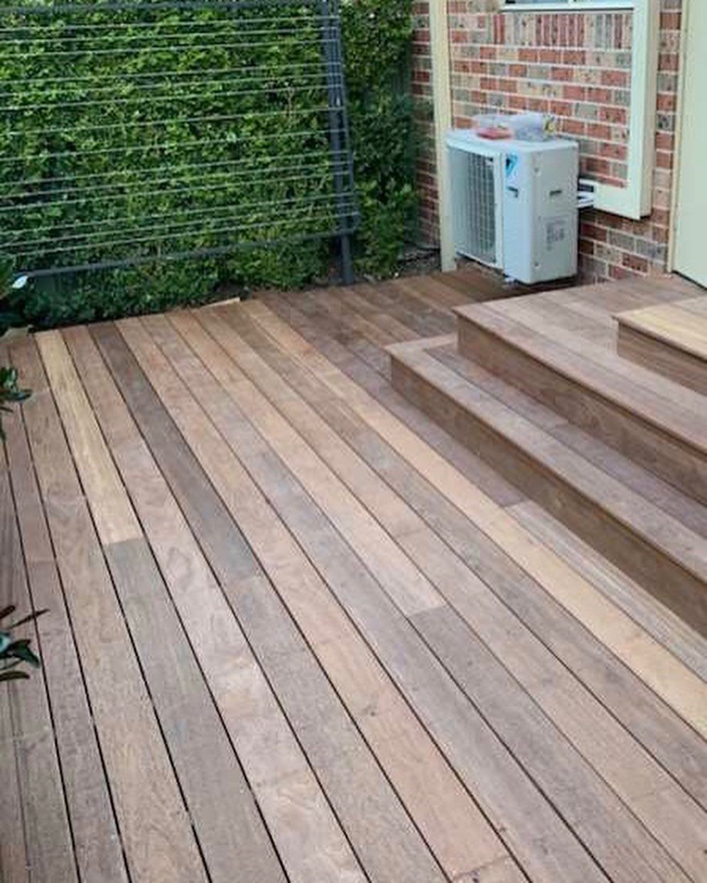 Wooden Deck With Steps Next to a Brick Wall — Narellan Home Improvement Centre In Narellan, NSW