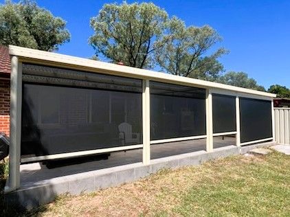 A Covered Outdoor Patio With Black Blinds — Narellan Home Improvement Centre In Narellan, NSW