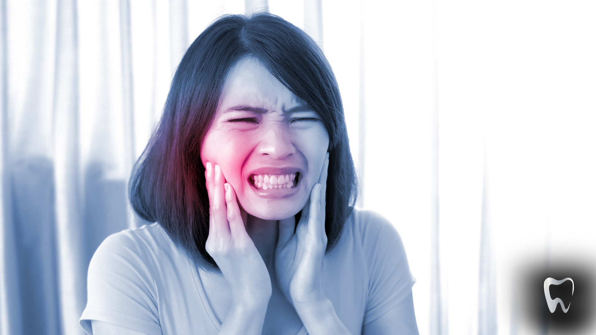A woman is holding her face in pain because of a toothache.