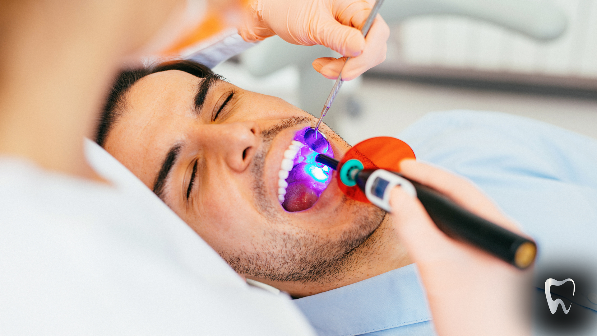 A man is getting his teeth examined by a dentist.