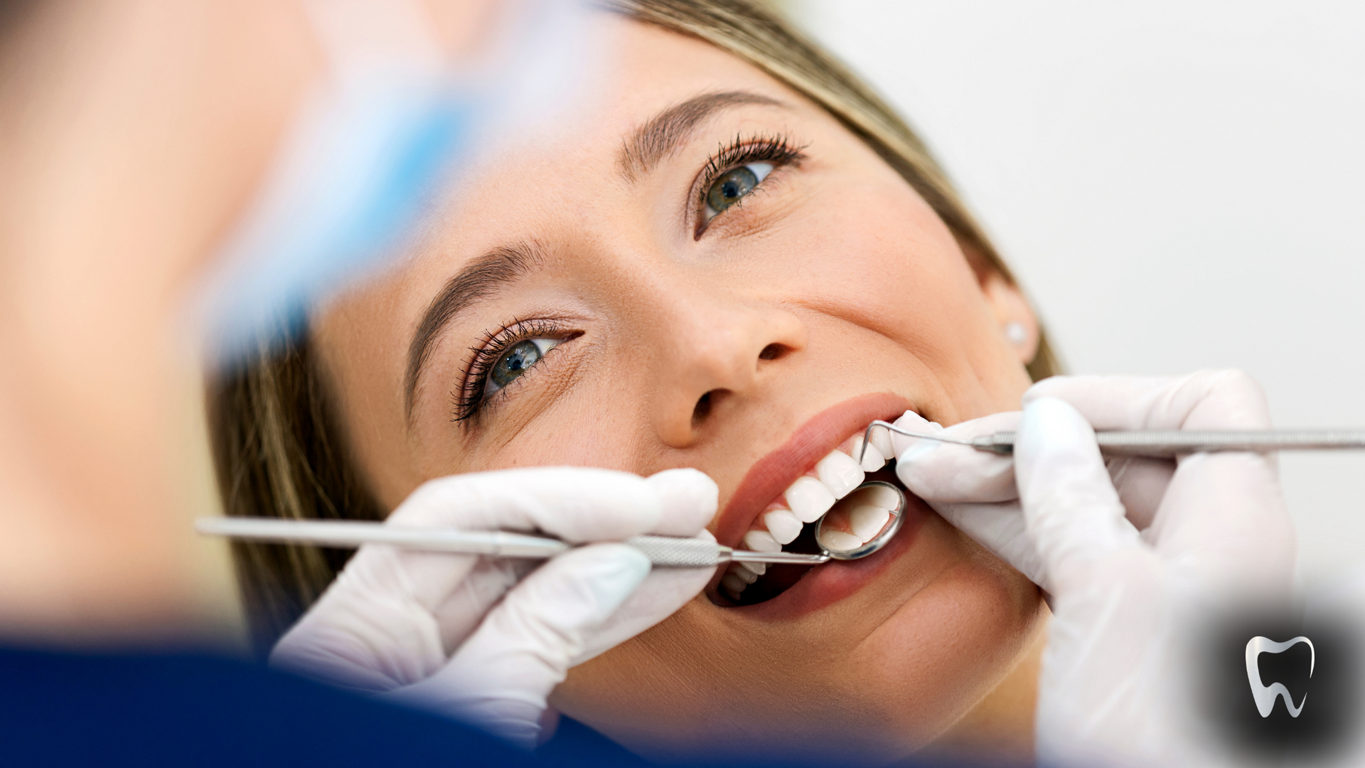 Woman in dental chair having her teeth examined.