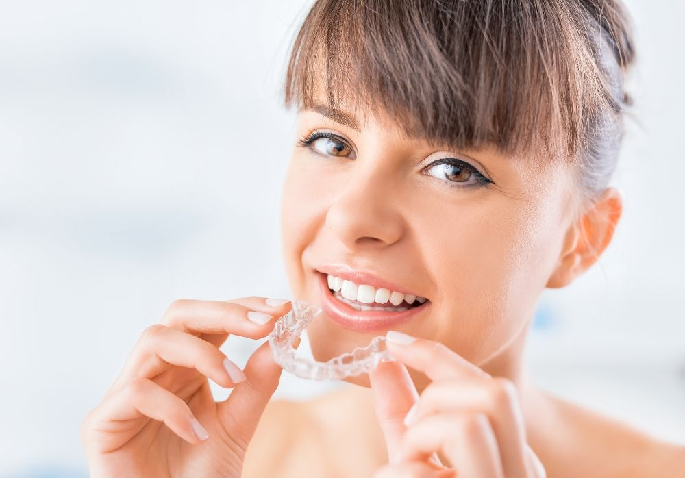 A woman is having her teeth examined by a dentist.