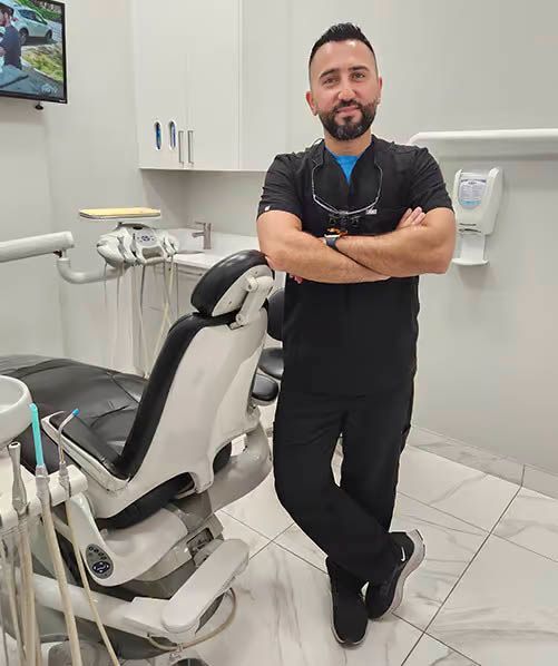 Woman at dentist's, mouth open, examined with mirror. Blue dental cloth, gloves.